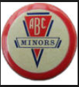 A circular badge in colours of red, white & blue. Text and logo reading, ABC Minors