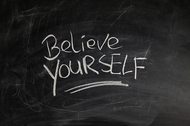 Chalk board with writing, "Believe Yourself" on it. Relating to writing Pen Portraits if you have a writers's block.